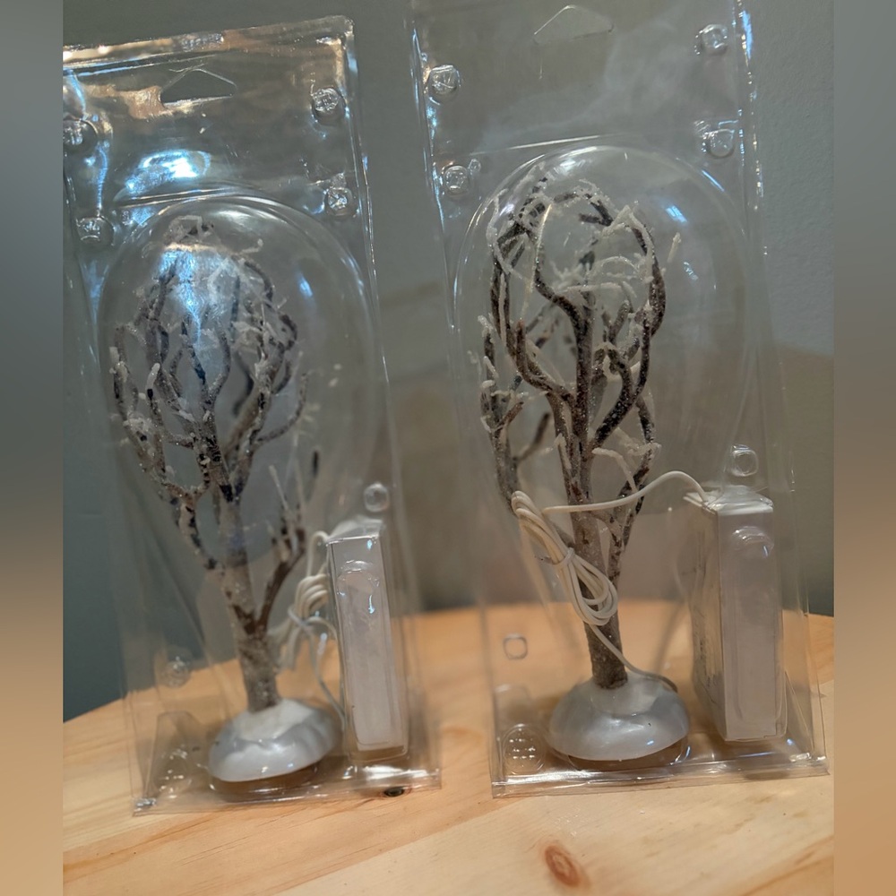 Set of lit Lemax Christmas trees